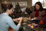 ANNA COX, left, gives Andrea Moreau her receipt and purchase at
Hobbs Inc., 700 Mass. Both Lawrence and Douglas County officials
learned Friday that sales tax revenues in the month after the Sept.
11 terrorist attacks increased compared to last year, according to
figures from the Kansas Department of Revenue.