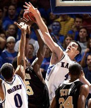 Kansas University's Nick Collison (4) skies to block a shot by Wake
Forest's Josh Howard in the second half. Collison finished with 16
points and 11 boards in the Jayhawks' 83-76 victory over the Demon
Deacons on Tuesday at Allen Fieldhouse.