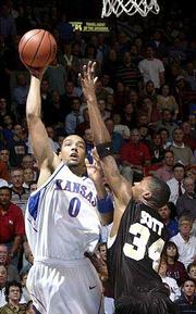 Kansas' Drew Gooden (0) launches a hook shot over Wake's Antwan
Scott. Gooden had 11 points in KU's 83-76 victory over the Demon
Deacons on Tuesday at Allen Fieldhouse.