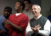 Incumbent KU quarterback Mario Kinsey, left, and KU basketball
coach Roy Williams laugh at a joke by new Kansas football coach
Mark Mangino. Running back Reggie Duncan, in background at left,
also attended Mangino's introductory press conference Tuesday at
Parrott Athletic Center.