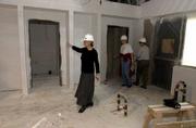 Ann Evans, director of the Lawrence Arts Center, left, gives a tour
of the new arts center under construction in the 900 block of New
Hampshire Street. Joining Evans on Wednesday afternoon were arts
center preschool teachers Linda Reimond, center, and Chris Hotvedt.