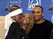 Actor Tyrese, left, kisses Ernestine Peters, center, executive
director of the NAACP Image Awards, as director John Singleton
looks on Wednesday as they pose for photographers after the
nominations for the NAACP Image Awards were announced at the Kodak
Theater in Los Angeles.