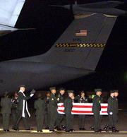 The coffin of an American soldier, who was killed by an errant U.S.
bomb in Afghanistan, arrives at the Ramstein Airbase in Germany.
The bodies of three American military personnel arrived late
Thursday from Afghanistan.