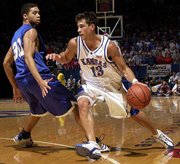 KU guard Jeff Boschee (13) drives on the Kangaroos' Michael
Jackson. Boschee finished with 19 points Saturday at Allen
Fieldhouse.