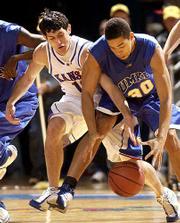 KU's Kirk Hinrich, left, hounds the Kangaroos' Michael Jackson.
Hinrich finished with 15 points, eight assists and zero turnovers
on Saturday.