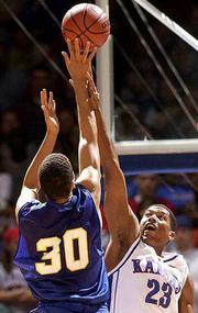 Kansas' Wayne Simien (23) skies to block a shot by UMKC's Michael
Jackson. Simien had 13 points in the Jayhawks' 79-68 victory
Saturday at Allen Fieldhouse.
