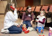 Sara Everly, 11, and Emily Miller, 12, practice their baby-sitting
skills with Kahlee Crossno, 3, during a recent Safe Sitter class at
Lawrence Memorial Hospital. During the daylong course, students
learn how to care for children and handle home emergencies.