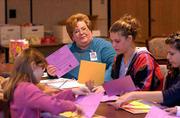 Alva Skiles, center, a registered nurse at Lawrence Memorial
Hospital, is one of the Safe Sitter class instructors. More than
200,000 young people have completed the international Safe Sitter
course.