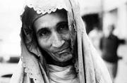 An Afghan woman begs for shoppers' change on the streets of
Peshawar as the war around her comes to a climax.