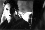Richard Gere, left, stars as a reporter who joins a police officer
(Laura Linney, reflected), to uncover a series of strange
happenings in "The Mothman Prophecies."
