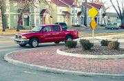 Vehicles slow down but keep moving at the traffic circle at Eighth
and Michigan streets, some neighborhood residents say. The circle
and its full-sized counterparts Lawrence's four roundabouts have
served their intended purpose of calming traffic, city officials
say.