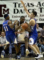 KU's Aaron miles, left, and Nick Collison double-up on Texas
A&M's Keith Bean. Bean scored his nine points in the first half
of the Aggies' 86-74 loss to the Jayhawks on Saturday at Reed
Arena.