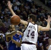 KU's Drew Gooden, left, fires a pass around Texas A&M's Tomas
Ress. The Jayhawks dropped the Aggies, 86-74, on Saturday in
College Station, Texas.