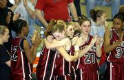 LHS sophomore Jodie Cochrane, right, and teammate Erin Knight hug.
Cochrane scored a team-high 11 points in the Lions' 71-41 loss to
Hutchinson in the finals of the Firebird Winter Classic on Saturday
at Free State High.