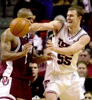 Andy Ellis of Texas Tech, right, passes around Oklahoma's Ebi Ere.
The Red Raiders defeated the Sooners, 92-79, on Saturday at
Lubbock, Texas.