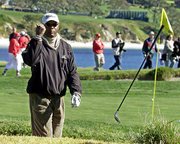 Actor Samuel L. Jackson tosses his wedge after failing to hit the
ball out of a sand bunker. Jackson was competing in the AT&T
Pebble Beach National Pro-Am on Wednesday at Pebble Beach Golf
Links in Pebble Beach, Calif.