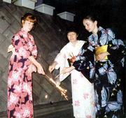 Marguerite Schumm, left, Satoko Morino, center, and Val Wiesner
wear traditional yukatas while lighting fireworks a favorite
Japanese activity at the Morino home in Hiratsuka.