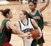 Free State's Stacie Garland, center, is hounded by Topeka Highland
Park's Geneen Taylor, left, and Cherice Swopes. The Firebirds won,
45-24, on Tuesday at FSHS.