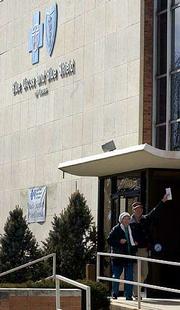 Customers exit the Blue Cross and Blue Shield of Kansas offices in
Topeka. Kansas Insurance Commissioner Kathleen Sebelius on Monday
rejected Anthem's bid to take over Kansas' largest health insurer.