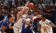 Kansas' Kirk Hinrich (10) breaks up a pass from Texas' Jason Klotz,
second from left, intended for T.J. Ford (11). Kansas beat the
Longhorns, 110-103 in overtime, on Monday in Austin, Texas.