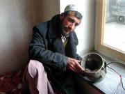 Saydamin, who uses only one name, holds a fragment of a rocket in
Kabul that struck his home in October, during the U.S. airstrikes.
His brother Saydiqbal with wife of six weeks were killed as they
slept.