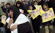 Iranians display anti-U.S. slogans during a rally in central
Tehran. Tens of thousands of people took part in activities Monday
marking the 23rd anniversary Iran&squot;s 1979 revolution. Posters read
"We will trample U.S. under our foot."