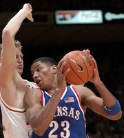 Kansas' Wayne Simien (23) drives on Jason Klotz. Simien had 17
points and 10 rebounds Monday in Austin, Texas.