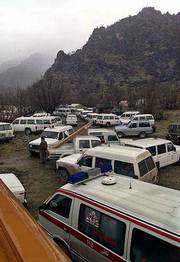 Dozens of ambulances and cars belonging to Iran's Red Crescent
remain parked at the foot of the Sefid Kouh mountains where a plane
crashed on Tuesday. All 118 passengers and crew on board the plane
are believed dead.