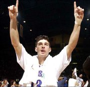 KU's Jeff Boschee shows the Jayhawks' new AP ranking. Boschee hit
three three-pointers and finished with nine points.