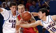 Ku's Jeff Boschee, left, and Kirk Hinrich converge on Iowa State's
Jake Sullivan. The Jayhawks hammered the Cyclones, 102-66, on
Monday at Allen Fieldhouse.