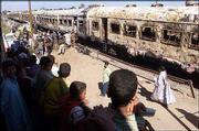 Onlookers watch recovery efforts from a burned train at Reqa
al-Gharbiya, Egypt, 60 miles south of Cairo. At least 370 people
were reported to have died Wednesday in a blaze that spread through
the crowded passenger train.