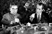 Chinese Premier Chou En-lai, left, and U.S. President Richard Nixon
and eat a banquet in Shanghai in this Feb. 28, 1972, file photo.
President Bush arrived today 30 years to the day after Nixon's
historic visit.