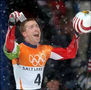 Jim SHea Jr., a third-generation U.S. Olympian, holds up a
photograph of his grandfather after winning gold in the skeleton.
Shea raced with the photo in his helmet Wednesday at Park City,
Utah. Jack Shea, who died last month, was a double-gold medalist
for the U.S. in speedskating at the 1932 Lake Placid Games.