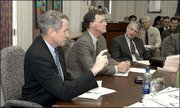 Kansas University provost David Shulenburger, left, explains the
reasoning behind proposed tuition increases. Kansas State
University Provost James Coffman, center, also offered comments at
the session. The provosts spoke to the state Superintendents
Council on Wednesday in Topeka.