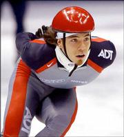 American Apolo Anton Ohno works out on the ice. Already the winner
of short-track gold and silver medals, the speed skater will try
for two more medals tonight.