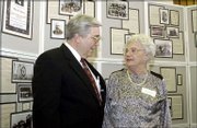 Visiting at the Walter S. Sutton Symposium at the Kansas University
Medical Center are Billy Hudson, left, professor and chairman of
the KU department of biochemistry and molecular biology, and Mrs.
Betsy Sutton, the wife of Dr. Walter S. Sutton's nephew. The Friday
symposium celebrated the 100th anniversary of Dr. Sutton's
discovery that chromosomes carry the units of inheritance and
honored Hudson's 28 years of kidney research at KU. Historical
displays from Dr. Sutton's days as both a KU student and surgery
professor are in the background.