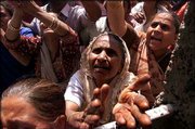 Muslim women plead to be rescued by police in Ahmadabad, India.
Chaos spread Friday through this western Indian city as the death
toll from three days of Hindu-Muslim violence climbed past 250,
despite patrols by hundreds of soldiers and orders for police to
shoot rioters and arsonists on sight.