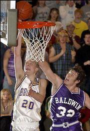Spring Hill's Mark Mathew, left, attempts a layup around Baldwin's
Micah Mason. The Bulldogs lost to the Mustangs, 55-48, in their
Class 4A sub-state semifinal on Friday at Mill Valley High.