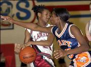 Lawrence's Audrey Pope, left, tangles with Olathe East's Tamara
Vincent. The Hawks beat the Lions, 52-39, on Saturday at Free State
High.