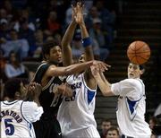 Jayhawks Keith Langford, left, Wayne Simien (23) and Kirk Hinrich
converge on David Harrison. KU drilled Colorado, 102-73, on Friday
at Kemper Arena.