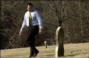 Under a budget plan before the Legislature, a funeral assistance
program for the poor would be eliminated. Larry McElwain, co-owner
and funeral director at Warren-McElwain Mortuary and Crematory
Services in Lawrence, walking in the pauper section at Oak Hill
Cemetery, says funeral homes will continue to provide services for
indigents, but that if the Legislature cuts the programs, the costs
will be shifted to the funeral homes and counties.