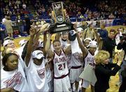 OKLAHOMA PLAYERS, including Big 12 player of the year and
tournament MVP Stacey Dales (21), hold up their trophy after
defeating Baylor, 84-69, in the championship game. The Sooners
claimed their first league tournament title Saturday night at
Municipal Auditorium in Kansas City, Mo. OU coach Sherri Coale is
at far right.