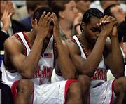 Maryland's Byron Mouton, left, and Chris Wilcox sit on the bench
during the final minute of the Terps' loss to N.C. State. The
Wolfpack won the ACC semifinal Saturday at Charlotte, N.C.