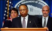 Deputy Atty. Gen. Larry Thompson, center, announces that the Arthur
Andersen accounting firm is being charged with obstruction of
justice. At left Thursday is Leslie Cauldwell, head of the Justice
Department task force investigating the accounting firm; at right
is Michael Chertoff, head of the criminal division of the Justice
Department.