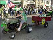 Kirby Wolfe, age 9, pulls his little brother Riley, 7, in an entry
that displayed both Irish and American spirit. American flags and
patriotic themes were prevalent throughout Sunday's St. Patrick's
Day Parade.