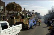 The Sandbar's pirate ship entry rolls its way down Massachusetts
street as its riders sing, dance, wave, and swim with the beat of
beach music. The bar's float won the best of show award in Sunday's
St. Patrick's Day parade.