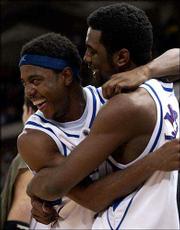 Jayhawks Aaron Miles, left, and Keith Langford, hug each other in
the waning moments of Sunday's Midwest Regional final in Madison,
Wis.