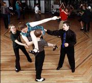 Elser and Bill Parrott, far right, help dancers Jamie Zerbe, 21,
and Loren Cunningham, 25, learn a new aerial maneuver.