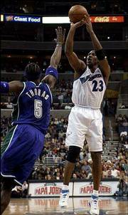 Washington's Michael Jordan, right, shoots over Milwaukee's Tim
Thomas. Jordan hit 12 of 22 shots in the Wizards' 107-98 victory
Friday night in Washington.