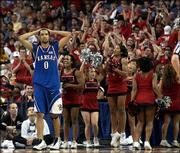 DREW GOODEN shows his frustration in the second half of the
Kansas-Maryland game as Terrapin cheerleaders and fans react with
happiness. The moment Saturday came as the Terps had just gone up
20 points on the Jayhawks. Kansas cut into the lead, but Maryland
ended the Jayhawks' run in the NCAA Tournament with a 97-88 win.